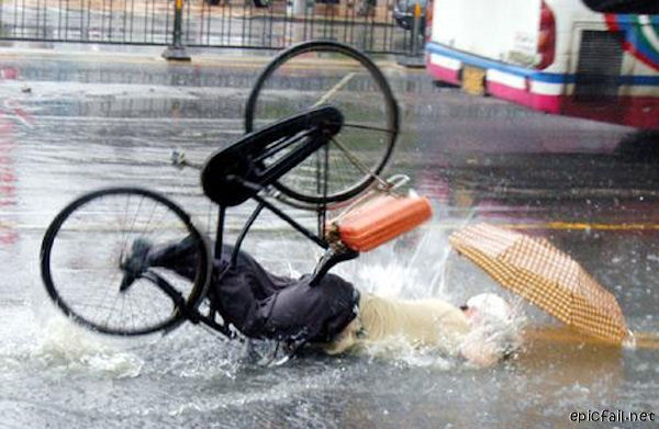 man wrecks bicycle in rain